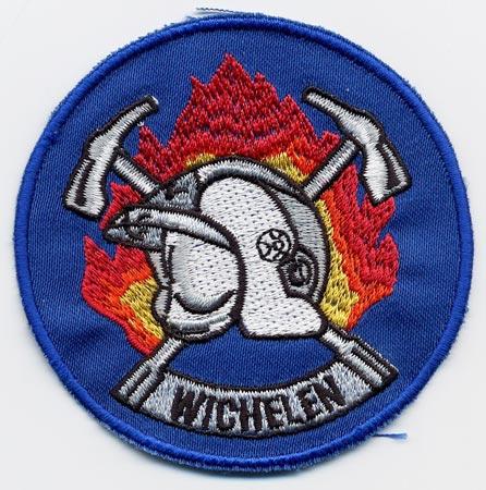 Wichelen - Distintivo azzurro con al centro un elmo su sfondo di fiamme