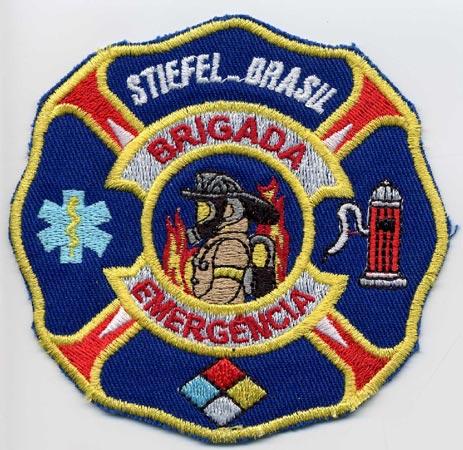 Stiefel - Distintivo azzurro con al centro un pompiere su sfondo di fiamme