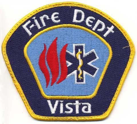 Vista - Distintivo blu con al centro fiamme e la croce azzurra medica