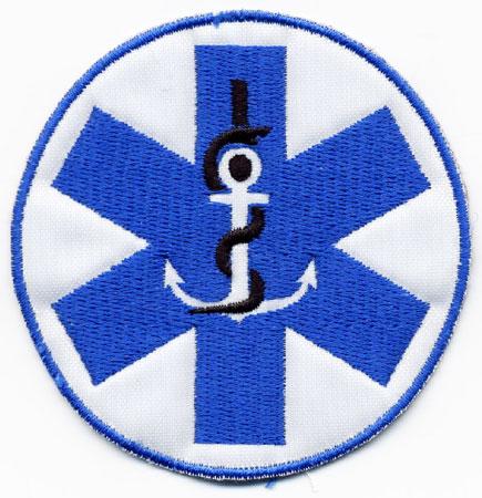 Eesti - Distintivo bianco con al centro croce medica azzurra