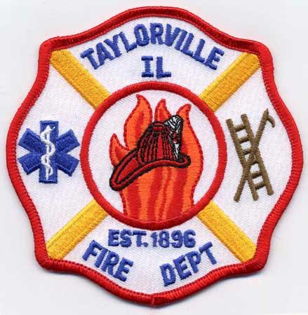 Taylorville - Distintivo bianco con al centro un elmo su sfondo di fiamme