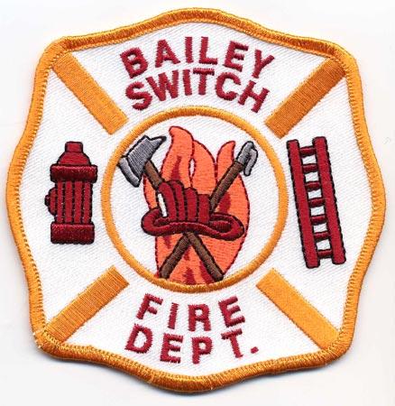 Bailey Switch - Distintivo bianco con al centro un elmo rosso su sfondo di fiamme