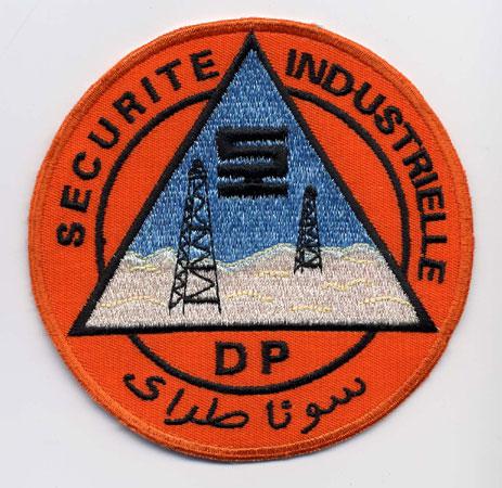 Morocco (Dp - Securite Industrielle) - Distintivo arancio con al centro un triangolo azzurro e bianco