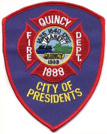 Quincy - Distintivo blu con diciture gialle e bianche