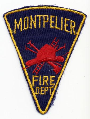 Montpelier - Distintivo blu con al centro un elmo rosso