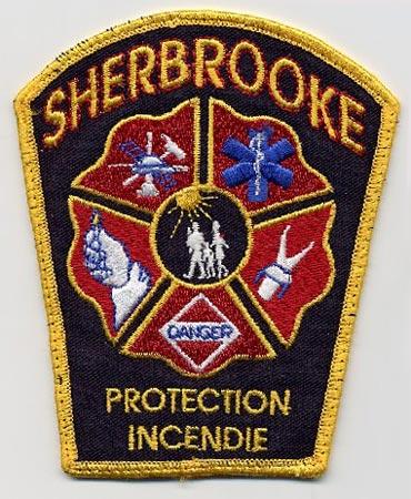 Sherbrooke - Distintivo nero con diciture gialle