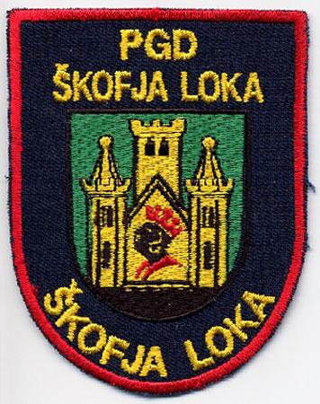 Skofja Loka - Distintivo blu con al centro un castello su sfondo verde