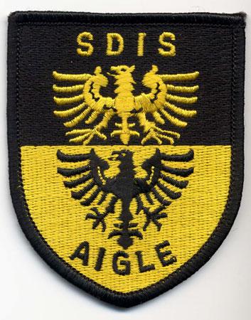 Aigle - Distintivo nero e giallo con al centro due aquile