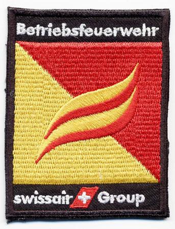 Basel (Swissair) - Distintivo giallo e rosso con il logo Swissair