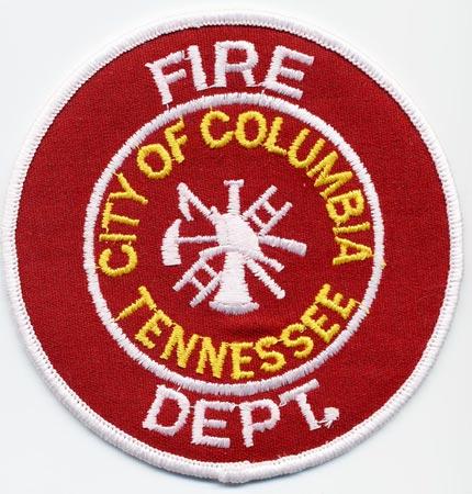 Columbia - Distintivo rosso con al centro un elmo bianco